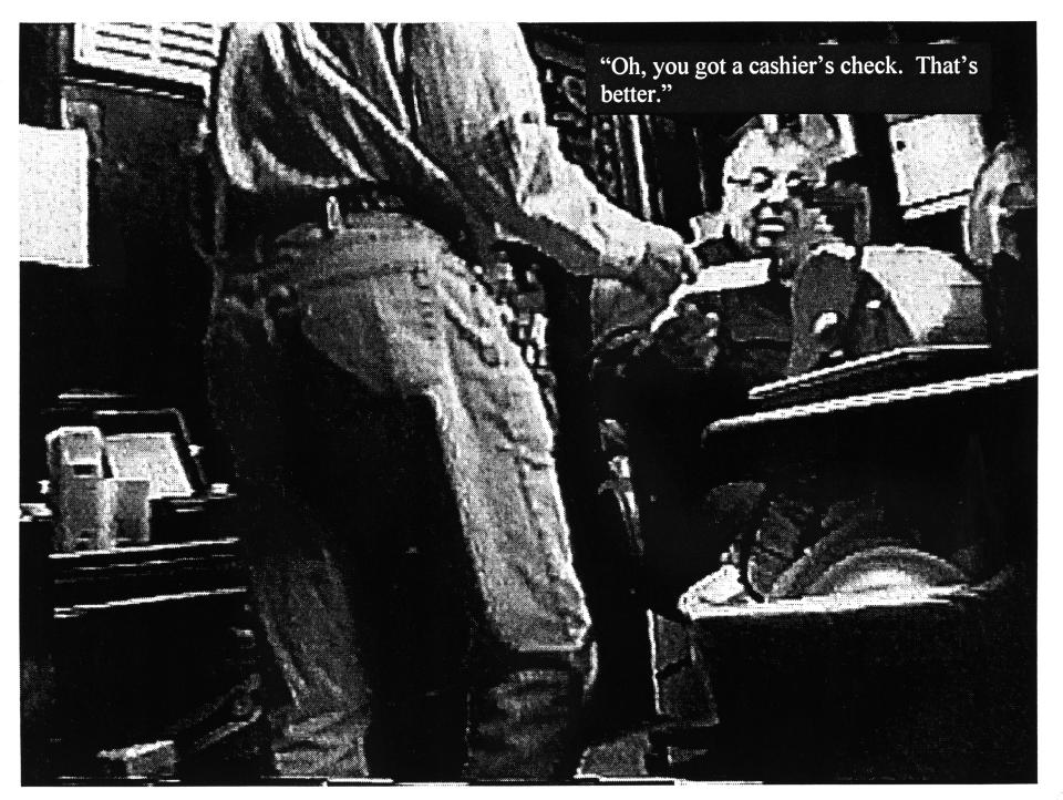 David C. Ead, vice chairman of the Providence Board of Tax Assessment Review, is seen apparently accepting a check from businessman Antonio R. Freitas during the Plunder Dome investigation. The still picture, taken from a secret videotape, was shown in court by federal prosecutors, along with the superimposed text, at a preliminary hearing.