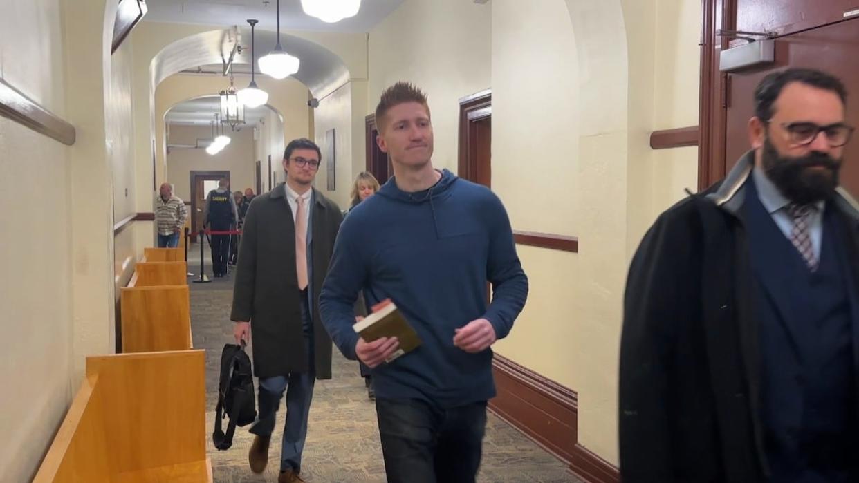 Matthew Day, centre, was one of two former Halifax Alehouse security guards charged with assault in relation to an incident on Oct. 10, 2022. The charges were thrown out on Tuesday. (Josh Hoffman/CBC - image credit)