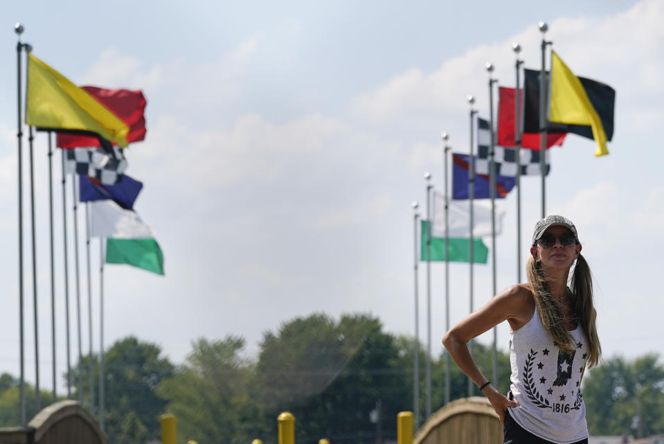 A fan watches the Indianapolis 500 auto race from outside of Indianapolis Motor Speedway, Sunday, Aug. 23, 2020, in Indianapolis. (AP Photo/Darron Cummings)