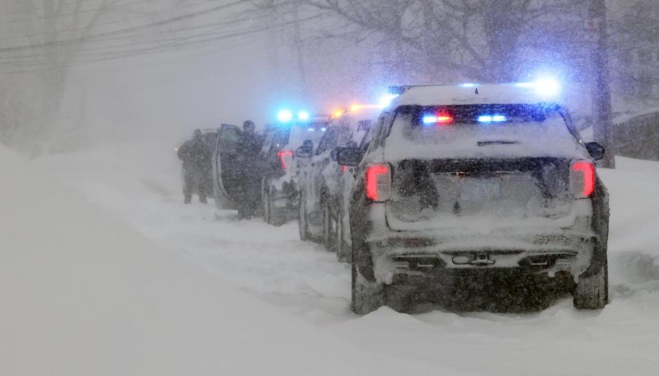 Police cruisers are covered by snow after officers responded to a domestic violence incident with a potentially armed suspect inside a home on Wyman Street on Saturday, Jan. 29, 2022. The incident occurred at the height of the weekend's blizzard.