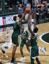 Michigan State's Aaron Henry, right, goes to the basket against Eastern Michigan's Ty Groce, left, and Miles Gibson (2) during the second half of an NCAA college basketball game Wednesday, Nov. 25, 2020, in East Lansing, Mich. Michigan State won 83-67. (AP Photo/Al Goldis)