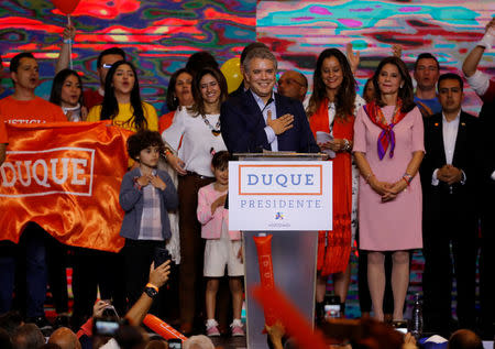 Right wing presidential candidate Ivan Duque, accompanied by his family, gestures after polls closed in the first round of the presidential election in Bogota, Colombia May 27, 2018. REUTERS/Nacho Doce