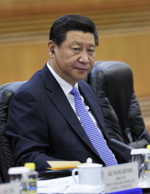 China's President Xi Jinping attends a meeting at the Great Hall of the People in Beijing, on November 8, 2014