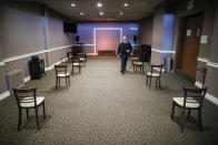 Pat Marmo, owner of Daniel J. Schaefer Funeral Home, walks through a viewing room set up to respect social distancing, Thursday, April 2, 2020, in the Brooklyn borough of New York. He and other funeral directors are seeing a surge of clients because of the coronavirus pandemic. (AP Photo/John Minchillo)