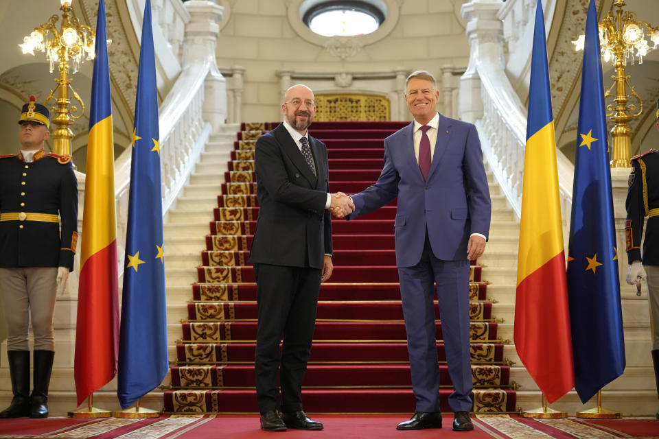 European Council President Charles Michel shakes hands with Romanian President Klaus Iohannis at the Cotroceni Presidential Palace in Bucharest, Romania, Monday, March 27, 2023. (AP Photo/Andreea Alexandru)