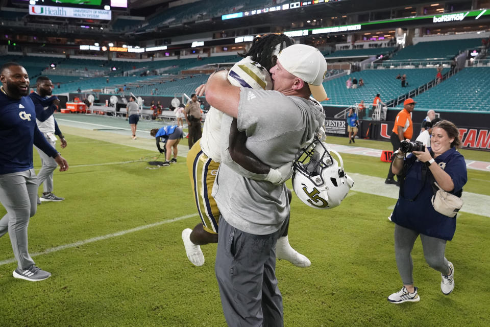 Georgia Tech head coach Brent Key picks up running back Jamal Haynes as they celebrate their 23-20 win over Miami in an NCAA college football game, Saturday, Oct. 7, 2023, in Miami Gardens, Fla. (AP Photo/Wilfredo Lee)