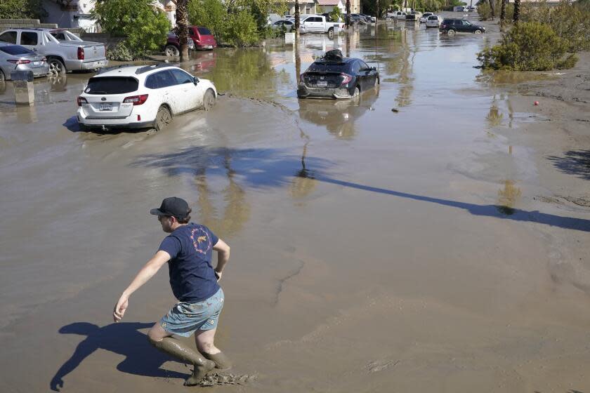 Cars are seen stuck in the mud on a street Monday, Aug. 21, 2023, in Cathedral City, Calif. Forecasters said Tropical Storm Hilary was the first tropical storm to hit Southern California in 84 years, bringing the potential for flash floods, mudslides, isolated tornadoes, high winds and power outages. (AP Photo/Mark J. Terrill)