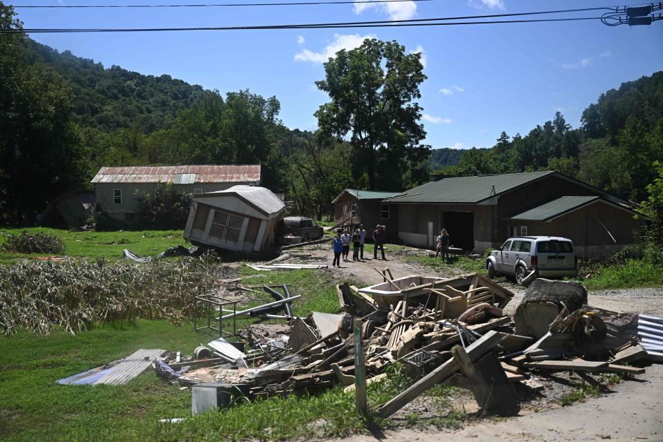 The Presidential motorcade drove past heavily damaged homes, caused by flood waters in Lost Creek, Kentucky (AFP via Getty Images)