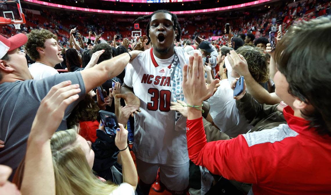 N.C. State’s D.J. Burns Jr. (30) is surrounded by fans as he exits the court after N.C. State’s 84-60 victory over Duke at PNC Arena in Raleigh, N.C., Wednesday, Jan. 4, 2023.
