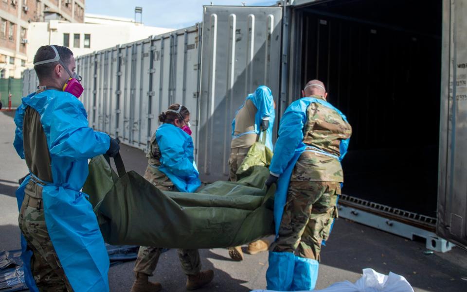 National Guard members assisting with processing COVID-19 deaths, placing them into temporary storage at the medical examiner-coroner's office in Los Angeles - LA County Department of Medical Examine r-Coroner