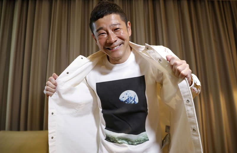 Japanese billionaire Yusaku Maezawa poses with his T-shirt bearing an image of Earth during an interview with Reuters in Tokyo