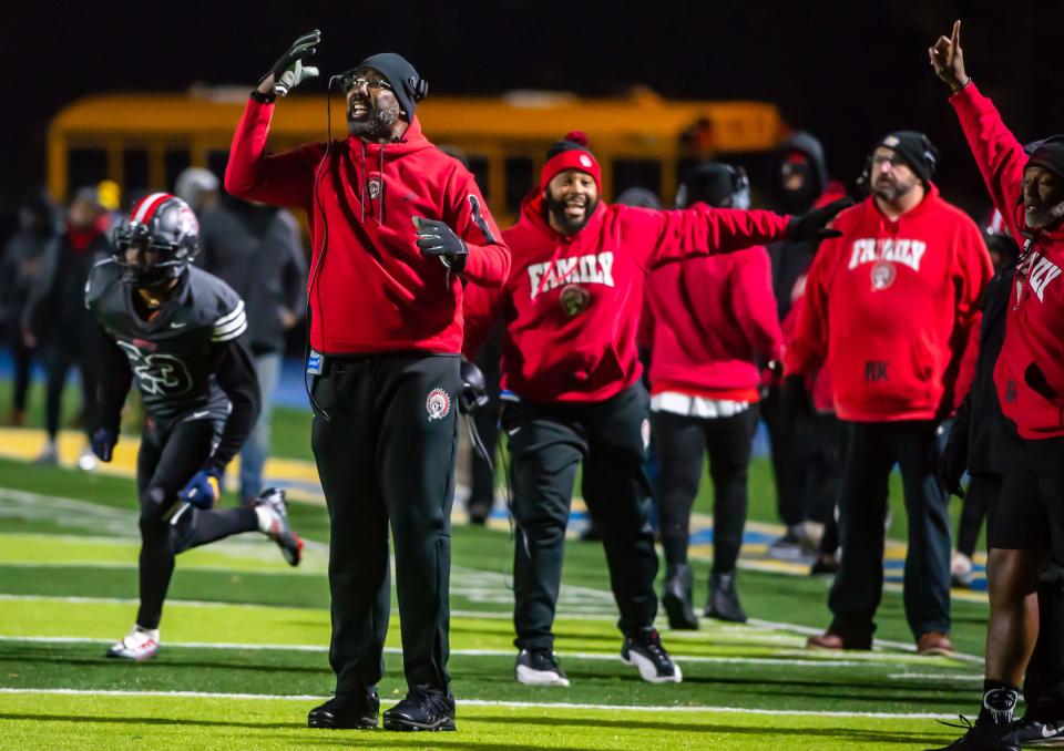 Aliquippa head coach Mike Warfield and his coaches yell instructions between plays of the Quips decisive win over  McKeesport 42-7 in the WPIAL Class 4A semifinal game Friday at Canon McMillan High School. [Lucy Schaly/For BCT]