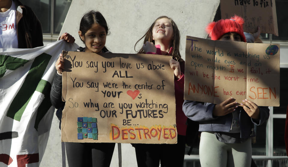 Students hold up signs outside the office of House Speaker Nancy Pelosi during a protest against climate change Friday, March 15, 2019, in San Francisco. Friday's rallies were one of the biggest international climate change actions yet, involving hundreds of thousands of students in more than 100 countries around the globe. (AP Photo/Ben Margot)