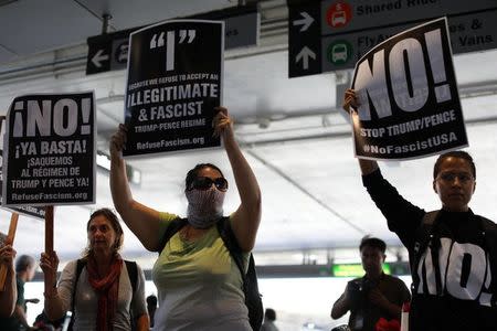 Protesters rally at Los Angeles International Airport to demonstrate against the reinstatement by the U.S. Supreme Court of portions of President Donald Trump's executive order targeting travellers from six predominantly Muslim countries, in Los Angeles, California, U.S., June 29, 2017. REUTERS/Mike Blake