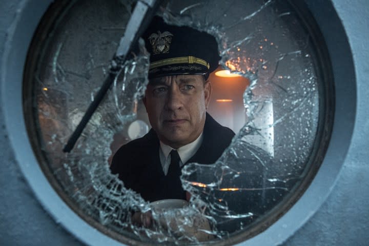 Tom Hanks looks through broken glass.