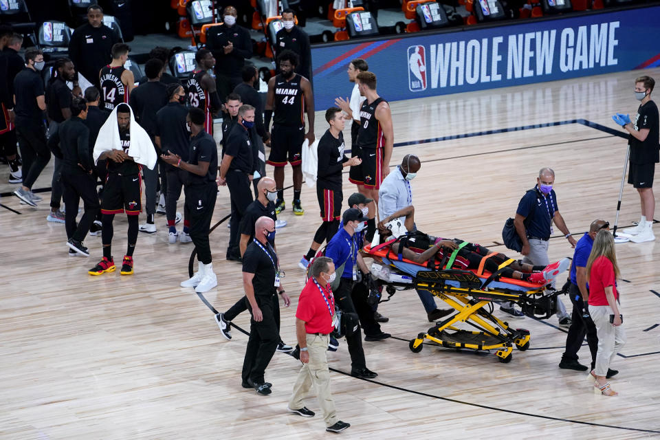 Miami Heat's Derrick Jones Jr is carried off the court on a stretcher after being injured against the Indiana Pacers during the second half of an NBA basketball game Monday, Aug. 3, 2020, in Lake Buena Vista, Fla. (AP Photo/Ashley Landis, Pool)