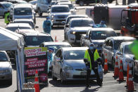 Cars queue at a COVID-19 test centre in Auckland, New Zealand, Thursday, Aug. 13, 2020. Health authorities in New Zealand are scrambling to trace the source of a new outbreak of the coronavirus as the nation's largest city goes back into lockdown. (AP Photo/Dean Purcel)