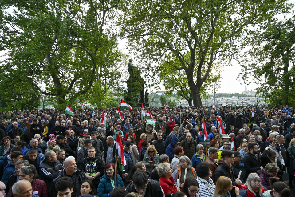 People protest outside the Hungarian Interior Ministry building to demand stronger protections for children and Interior minister Sandor Pinter to step down, in Budapest, Hungary, Friday, April 26, 2024. Peter Magyar, a former insider within Orban's ruling Fidesz party, lead a protest. The demonstration was the latest in a series of large anti-government protests that Magyar has mobilized in recent weeks, and comes as the political newcomer is campaigning for EU elections this June with his new party, Respect and Freedom (TISZA). (AP Photo/Denes Erdos)