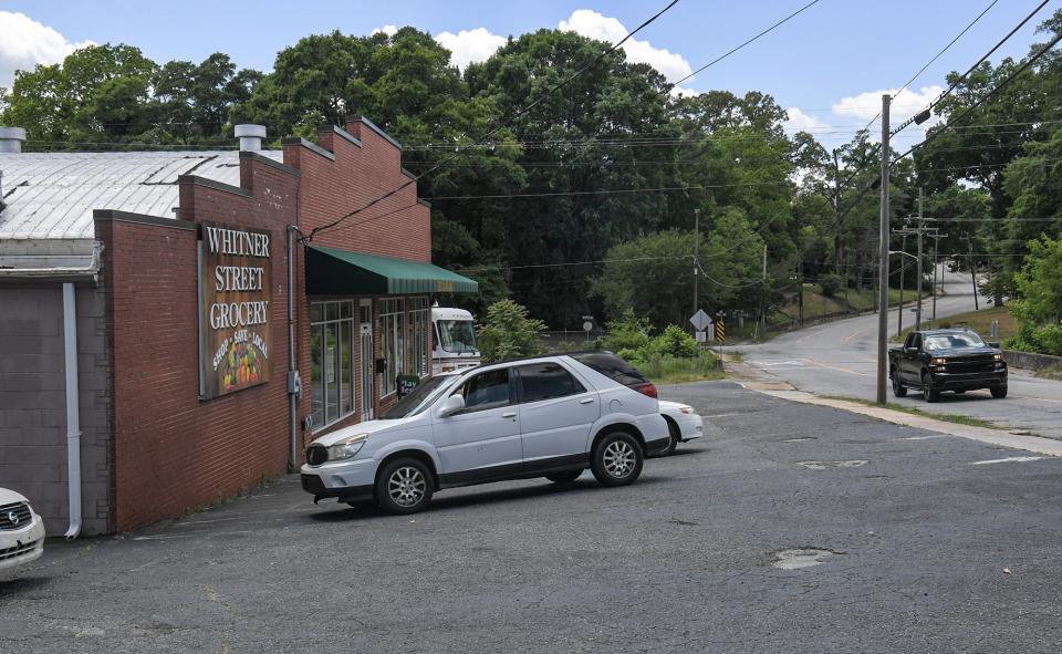 Cars drive by and park at West Whitner Grocery store in Anderson, S.C. Thursday, May 12, 2022. 