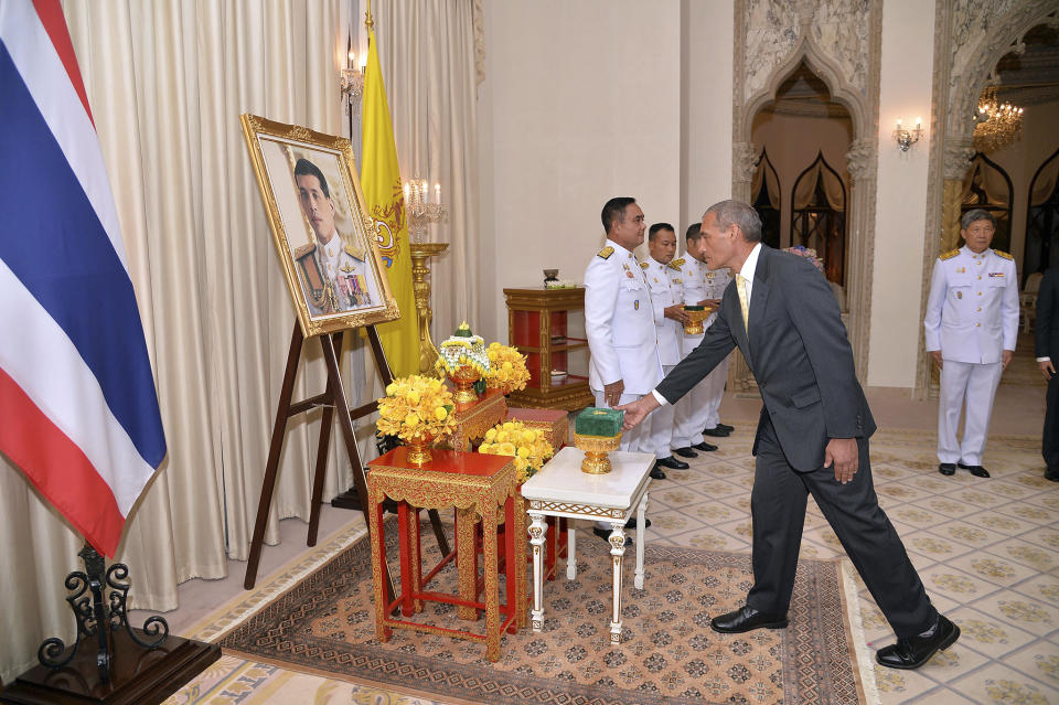 In this photo released by Government Spokesman Office, Craig Challen, an Australian member of the Thai cave rescue team, receives the Member of the Most Admirable Order of the Direkgunabhorn in front of a portrait of Thailand's King Maha Vajiralongkorn Bodindradebayavarangkun during the royal decoration ceremony at the Royal Thai Government House in Bangkok, Thailand, Friday, April 19, 2019. Two Australian doctors, Challen and Richard Harris received royal honors for helping rescue the Wild Boars soccer team from a flooded cave (Government Spokesman Office via AP)