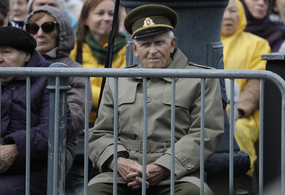 People wait for the arrival of Pope Francis, outside the Museum of Occupations and Freedom Fights, in Vilnius, Lithuania, Saturday, Sept. 22, 2018. Pope Francis is on a four-day visit to the Baltics amid renewed alarm about Moscow's intentions in the region it has twice occupied. (AP Photo/Andrew Medichini)