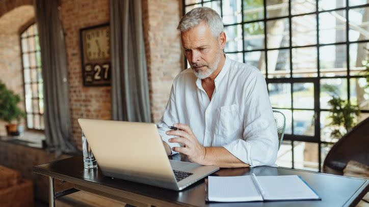 A man reviews his assets and expenses as he builds a financial plan for retirement.