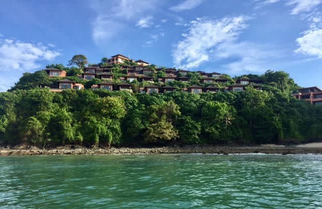 The villas are perched along the side of a cliff