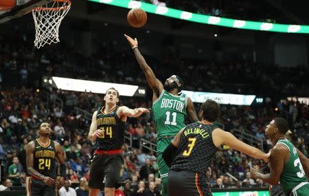 Nov 18, 2017; Atlanta, GA, USA; Boston Celtics guard Kyrie Irving (11) shoots against Atlanta Hawks forward Tyler Cavanaugh (34) and guard Marco Belinelli (3) in the fourth quarter at Philips Arena. Mandatory Credit: Jason Getz-USA TODAY Sports