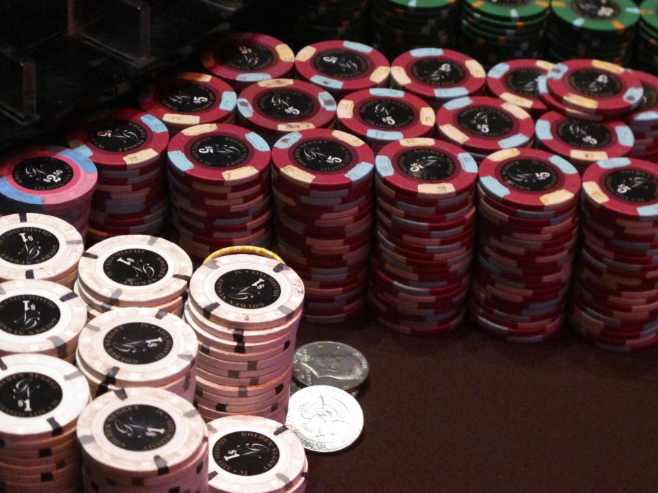 This Feb. 22, 2019 photo shows stacks of gambling chips at the Golden Nugget casino in Atlantic City N.J. As of Monday, March 16, 2020, casinos in at least 15 states had shut down due to the coronavirus, including Atlantic City's nine casinos which were due to close at 8 p.m. (AP Photo/Wayne Parry)