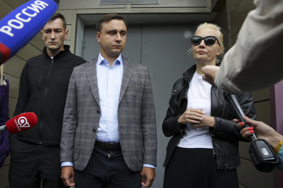 FILE - In this Aug. 21, 2020, file photo, Alexei Navalny's brother Oleg Navalny, left, Navalny's colleague Ivan Zhdanov, center, and Alexei Navalny's wife Yulia speak to the media at the Omsk Ambulance Hospital No. 1, where the opposition leader was hospitalized in Omsk, Russia. Rattled by the nationwide demonstrations in support of the Kremlin foe, authorities are moving rapidly to block any new ones – from piling legal pressure on his allies and aides to launching a campaign to discredit the demonstrations. On Wednesday, Jan. 17, 2021, Moscow police raided apartments and offices belonging to Navalny associates and opposition figures, including his own apartment and his brother's. (AP Photo/Evgeniy Sofiychuk, File)