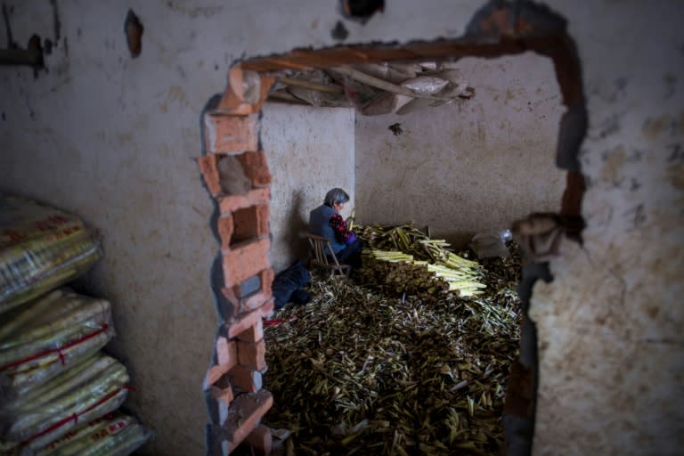 A woman cleans bamboo shoots at a market in Taihuyuan village near the city of Lin'an, Zhejiang Province