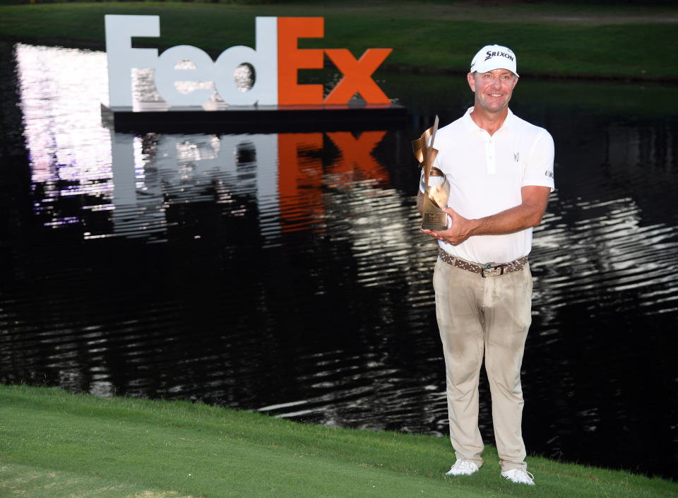 Lucas Glover poses for a photo with the championship trophy after winning a playoff hole against Patrick Cantlay during the final round of the FedEx St. Jude Championship golf tournament. Mandatory Credit: Christopher Hanewinckel-USA TODAY Sports