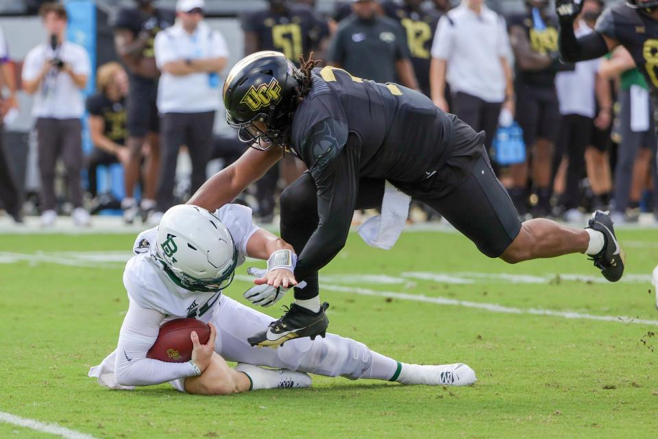 Baylor Bears quarterback Blake Shapen (12) is sacked by UCF Knights defensive end Tre'Mon Morris-Brash (3) during the second quarter Sept. 30, 2023, at FBC Mortgage Stadium in Orlando, Florida.