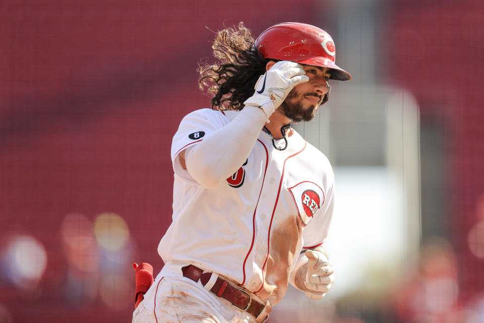 Cincinnati Reds' Jonathan India fixes his hair as he runs the bases after hitting a two-run home run during the seventh inning of a baseball game against the Pittsburgh Pirates in Cincinnati, Monday, Sept. 27, 2021. (AP Photo/Aaron Doster)