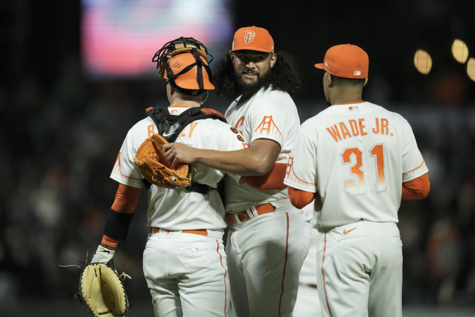 San Francisco Giants pitcher Sean Manaea, center, celebrates with catcher Patrick Bailey, left, and first baseman LaMonte Wade Jr. after the team's 4-3 victory over the Arizona Diamondbacks in a baseball game Tuesday, Aug. 1, 2023, in San Francisco. (AP Photo/Godofredo A. Vásquez)