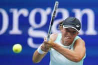 FILE - Iga Swiatek, of Poland, returns a shot to Ons Jabeur, of Tunisia, during the women's singles final of the U.S. Open tennis championships, Saturday, Sept. 10, 2022, in New York. Top-ranked Iga Swiatek and 18-year-old American Coco Gauff have been drawn into the same round-robin group at the WTA Finals, which starts Monday, Oct. 31, 2022. (AP Photo/Matt Rourke, File)