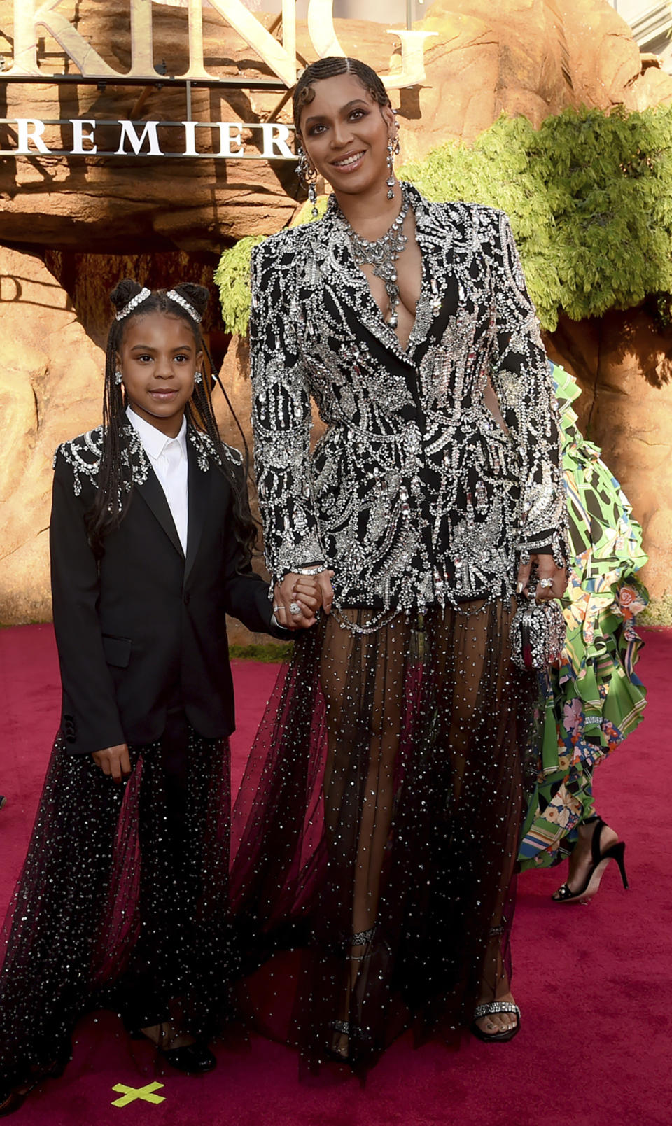 FILE - In this July 9, 2019 file photo, Beyonce, right, and her daughter Blue Ivy Carter arrive at the world premiere of "The Lion King" at the Dolby Theatre in Los Angeles. At just 7, Blue Ivy Carter is an award-winning songwriter. Jay-Z and Beyoncé’s daughter won the Ashford & Simpson Songwriter’s Award at the Soul Train Awards on Sunday, Nov. 17 for co-writing her mom’s hit “Brown Skin Girl,” a song celebrating dark- and brown-skinned women. Ivy gives a vocal performance that opens and closes the song, which also features Wizkid and Saint Jhn. (Photo by Chris Pizzello/Invision/AP, File)