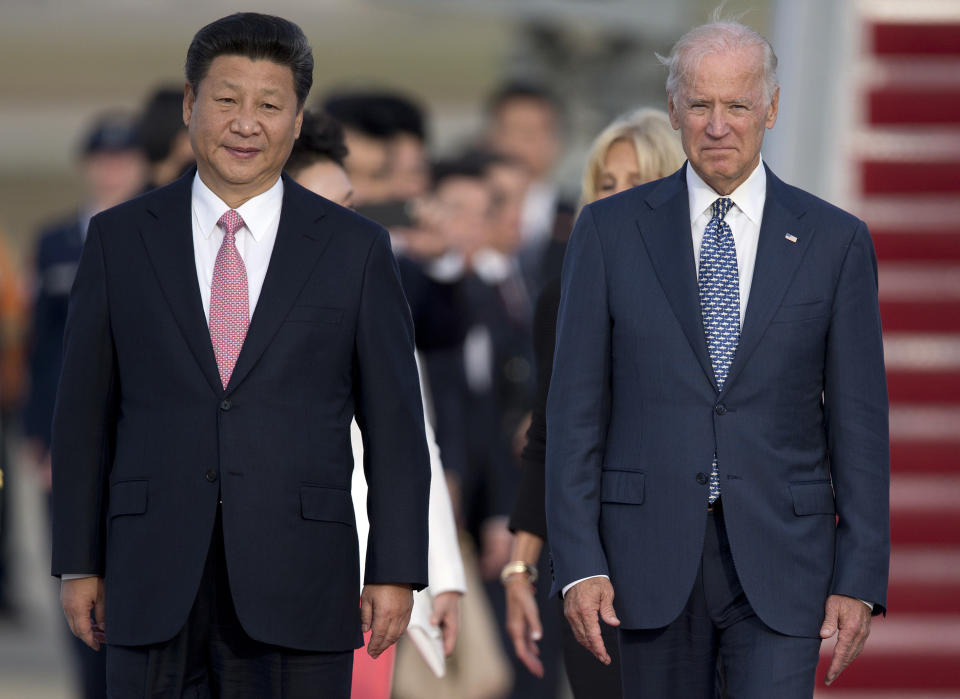 FILE - In this Sept. 24, 2015, file photo Chinese President Xi Jinping and Vice President Joe Biden walk down the red carpet on the tarmac during an arrival ceremony in Andrews Air Force Base, Md. China has fast become a top election issue as President Donald Trump and Democrat Joe Biden engage in a verbal brawl over who's better at playing the tough guy against Beijing. (AP Photo/Carolyn Kaster, File)