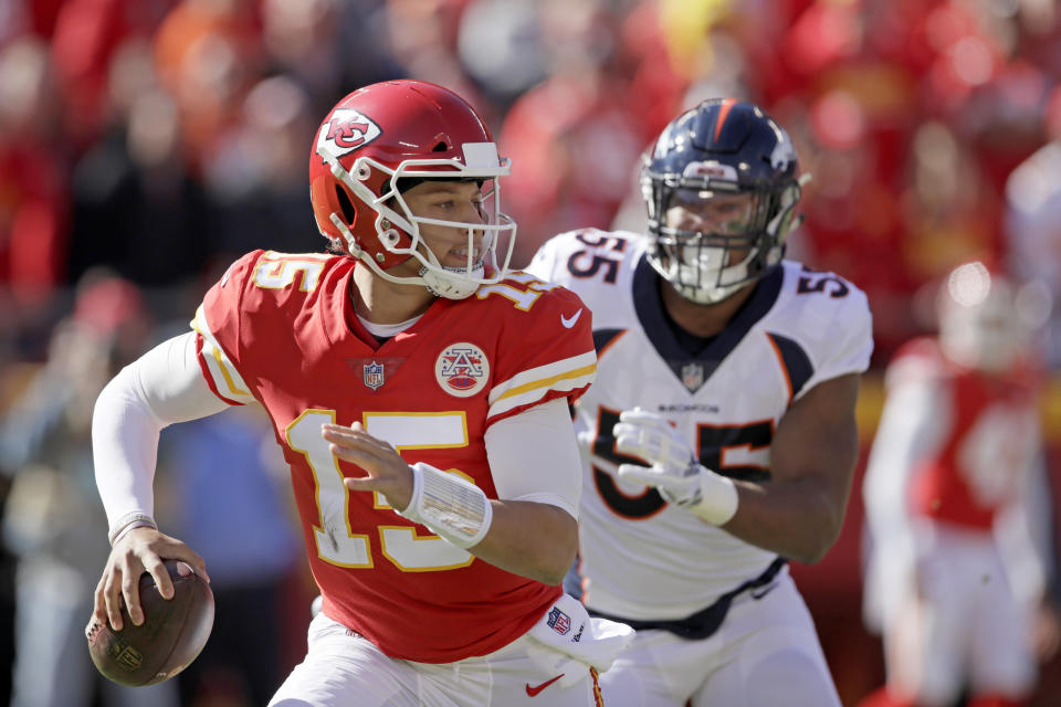Kansas City Chiefs quarterback Patrick Mahomes (15) is chased by Denver Broncos linebacker Bradley Chubb (55) as he looks for a receiver during the first half of an NFL football game in Kansas City, Mo., Sunday, Oct. 28, 2018. (AP Photo/Orlin Wagner)