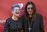 Musician Ozzy Osbourne (R) and his daughter Kelly Osbourne pose at the 10th Annual MusiCares MAP Fund Benefit concert at Club Nokia in Los Angeles, California May 12, 2014. REUTERS/Mario Anzuoni (UNITED STATES - Tags: ENTERTAINMENT)