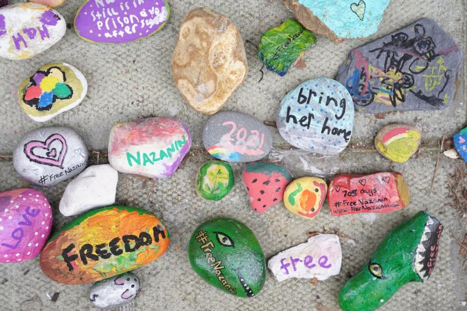 Stones with messages beside Richard Ratcliffe outside the Foreign Office in London (Kirsty O’Connor/PA). (PA Wire)