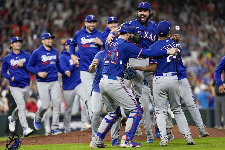 The Texas Rangers celebrate after Game 7 of the baseball AL Championship Series against the Houston Astros Monday, Oct. 23, 2023, in Houston. The Rangers won 11-4 to win the series 4-3. (AP Photo/David J. Phillip)