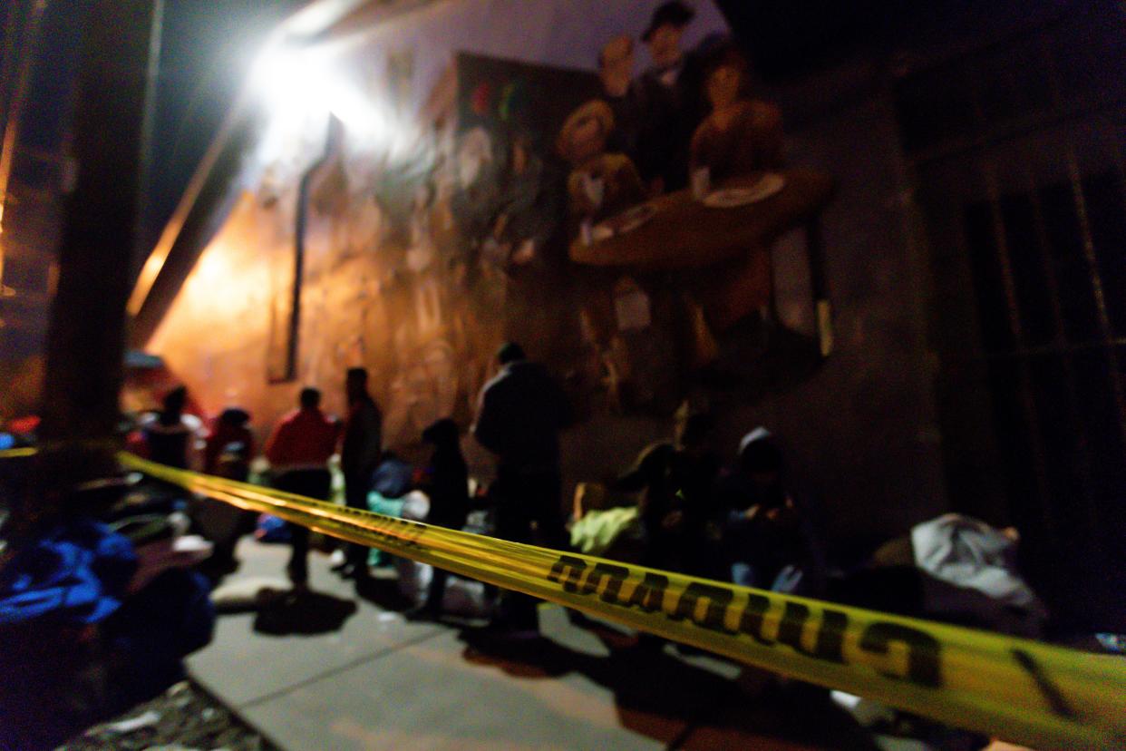 Venezuelan women migrants with children wait in line to be let inside to stay warm at the Sacred Heart Church on Wednesday night, Jan. 4, 2023.