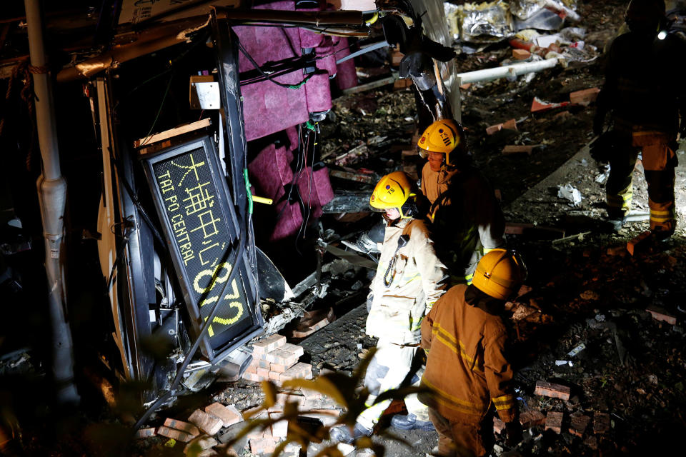 <p>Rescuers walk beside a crashed bus in Hong Kong, China, Feb. 10, 2018. (Photo: Bobby Yip/Reuters) </p>