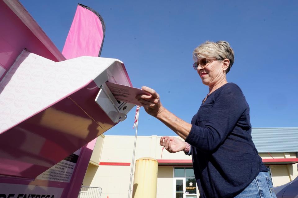 Susan Johnson casts her California primary ballot at a drop-off box outside the Sacramento County Registrar of Voters office in Sacramento, Calif., Tuesday, June 7, 2022