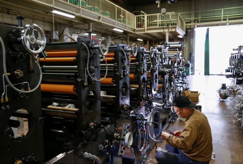 A worker checks machinery at a factory in Higashiosaka