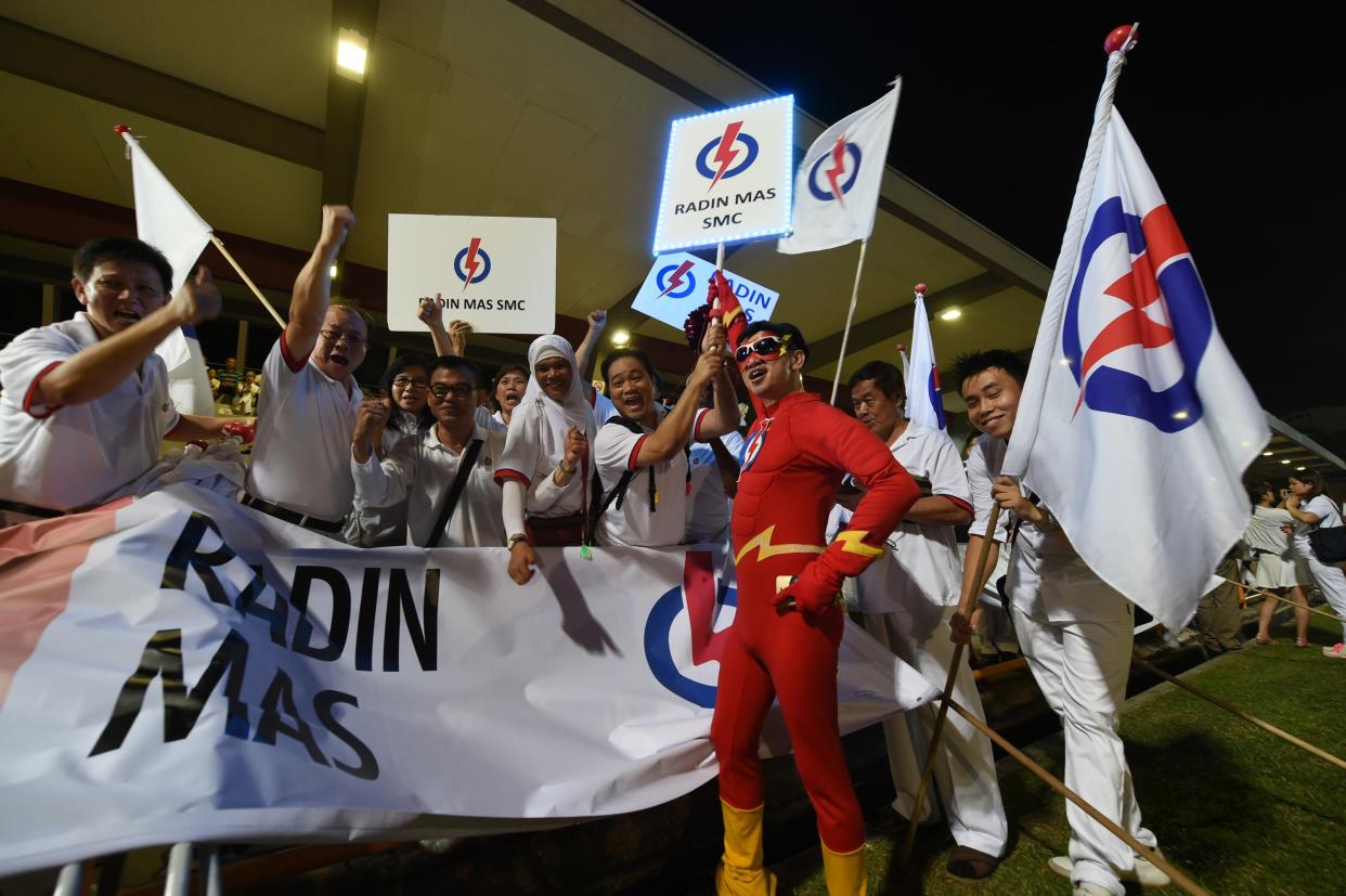 Supporters of the People's Action Party gather at Toa Payoh stadium while waiting for general election results in Singapore on September 11, 2015. Polling stations opened across Singapore on September 11 for a snap election called by Prime Minister Lee Hsien Loong amid an economic slowdown. AFP PHOTO / ROSLAN RAHMAN        (Photo credit should read ROSLAN RAHMAN/AFP via Getty Images)