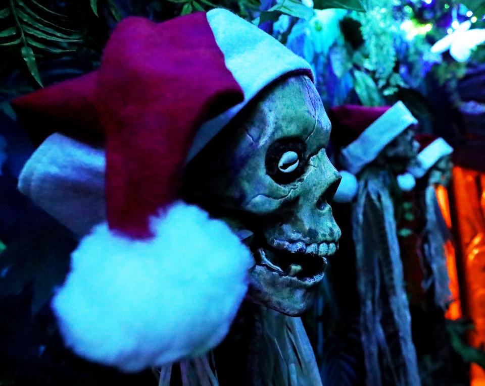 The skulls at Tiki Underground wear Santa Claus hats at the holiday pop-up Mele Kalikimaka in Cuyahoga Falls.