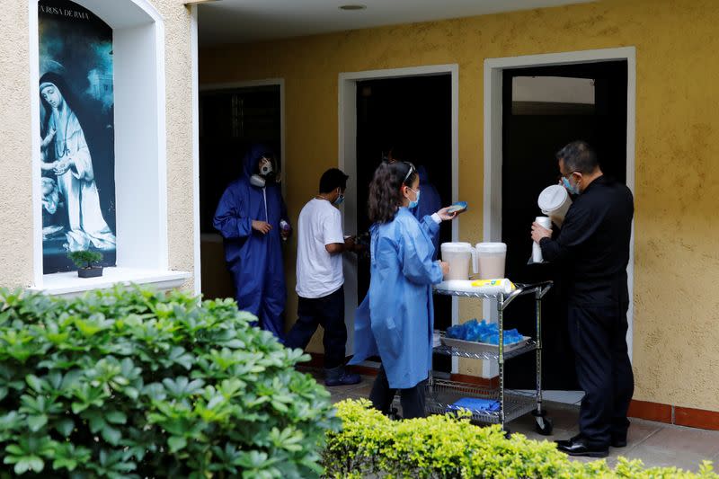 Fray Carlos Caceres and a worker serve food to unaccompanied minors who were deported from the U.S., at a shelter in Guatemala City