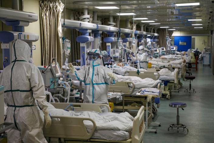 Medical workers in protective suits attend to novel coronavirus (COVID) patients at the intensive care unit (ICU) of a designated hospital in Wuhan, Hubei province, China, February 6, 2020.